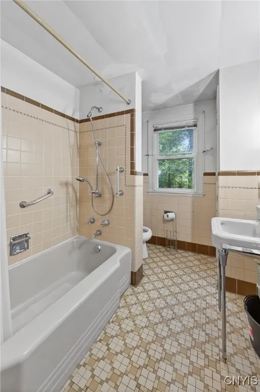 The bathroom has a classic, mid century feel.