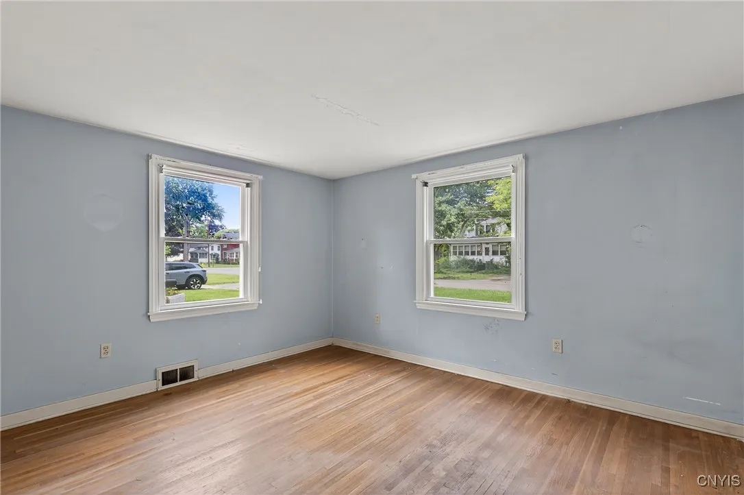 The first bedroom is in the front of the house.  Light blue paint and hardwoods make decorating easy!