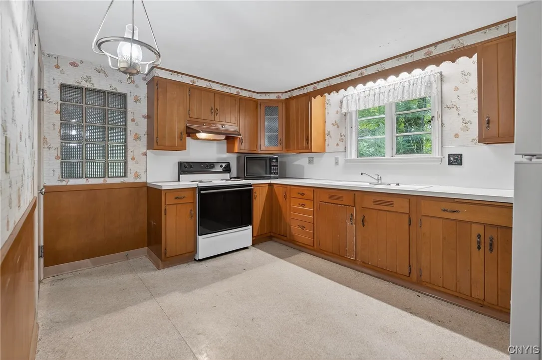 Plenty of cabinet space in the kitchen!  The glass block window into the garage adds light without detracting from the wall.