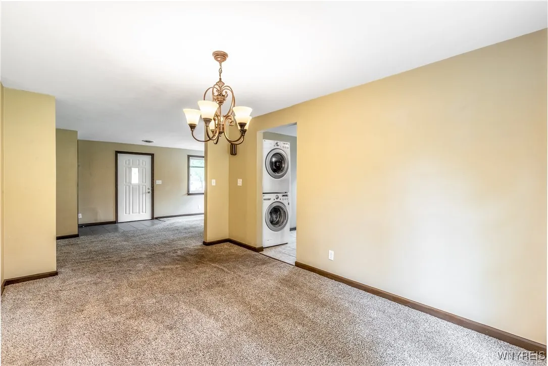 This picture is from back of dining room.  You can see the stackable washer / dryer set at the end of the kitchen.