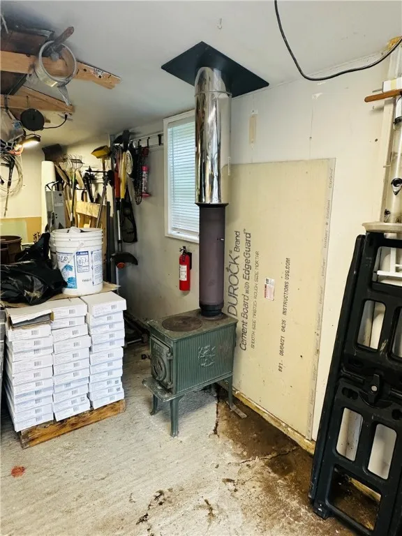 The garage is heated, with both a wood stove and electric baseboard.