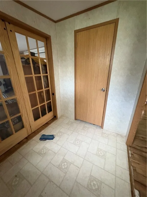 front entry with closet and barn door entry to family room