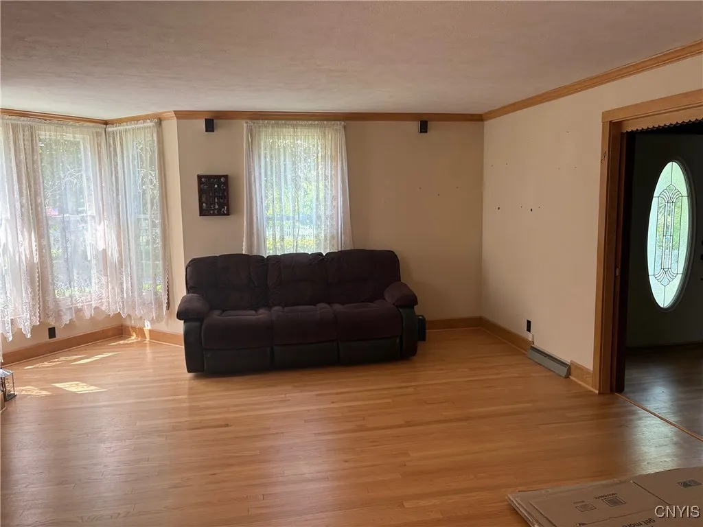 Living room with hardwood floors and plenty of natural light