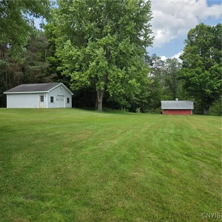 Detached 2 car garage and Shed. Concrete flooring and electricity.