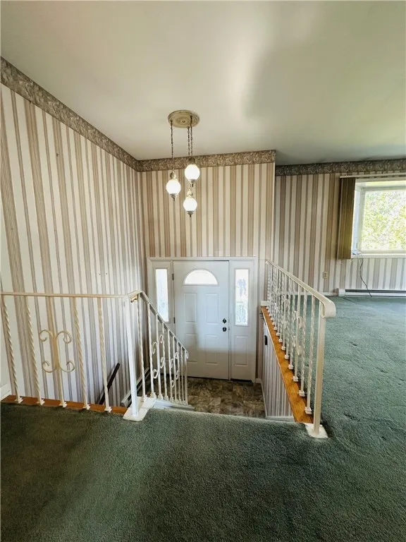 The front entrance and the stairs leading to the first floor.