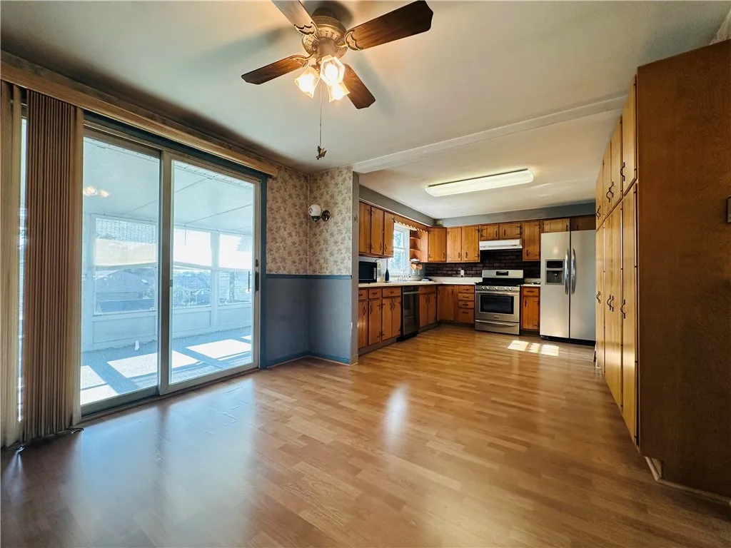 The large eat in kitchen has a sliding door to the upper level sun room.