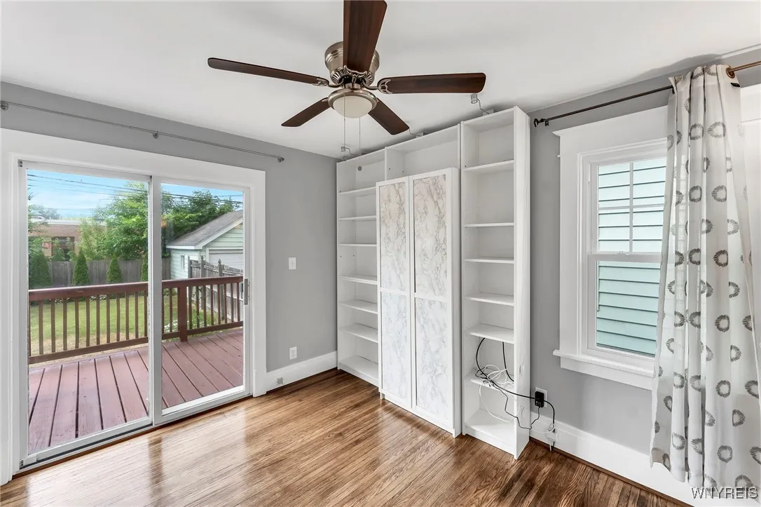 Downstairs, bedroom 2 with sliding glass door to freshly painted deck. Shelves stay.