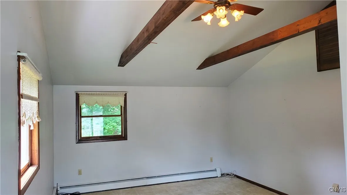   The primary bedroom is huge !! Vaulted ceilings with real beams.