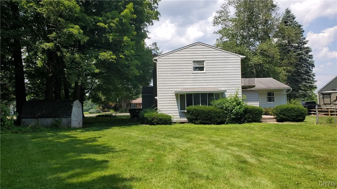 Rear view of home.  There are 2 sheds on the property,  one on the right side
  of the home,  other is near the in-ground pool for pool equipment.
