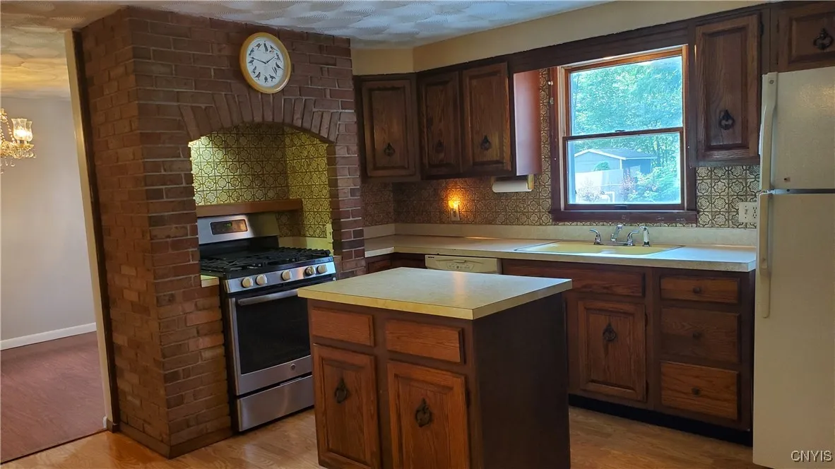   Newer gas,  stove/oven.  Real brick surround around the stove.