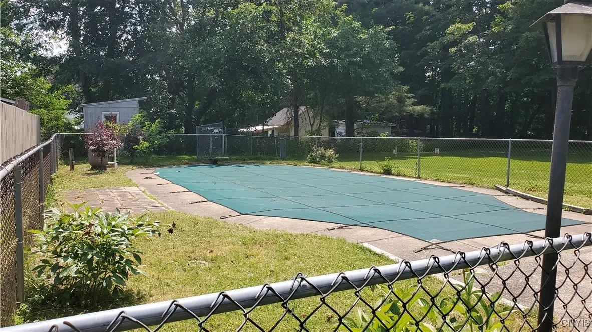    In-ground pool with pool shed in rear