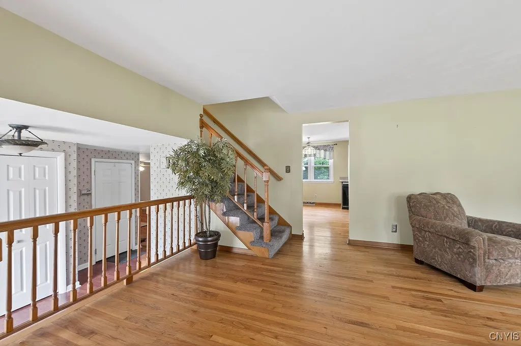 Large front living room with access to the kitchen, upstairs and dining room
