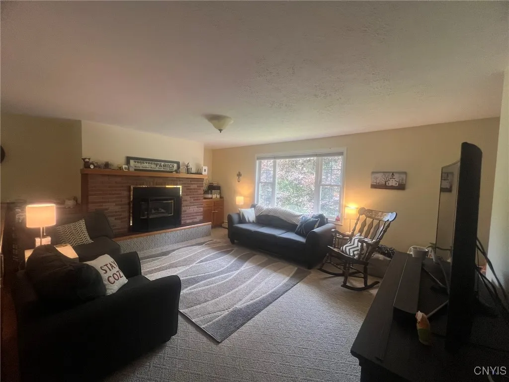 Living room with gas fireplace and large window for tons of natural light