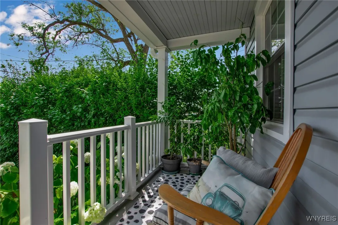 Relax on the inviting front porch, surrounded by lush, vibrate foliage.