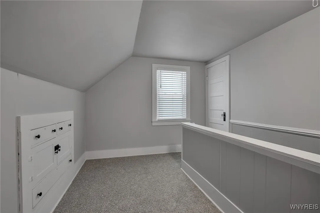 Upstairs landing w/ built-in drawers and attic access.