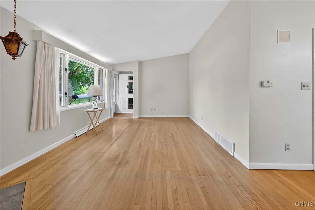 View of the living room, with the picture window on the right and main enterance.