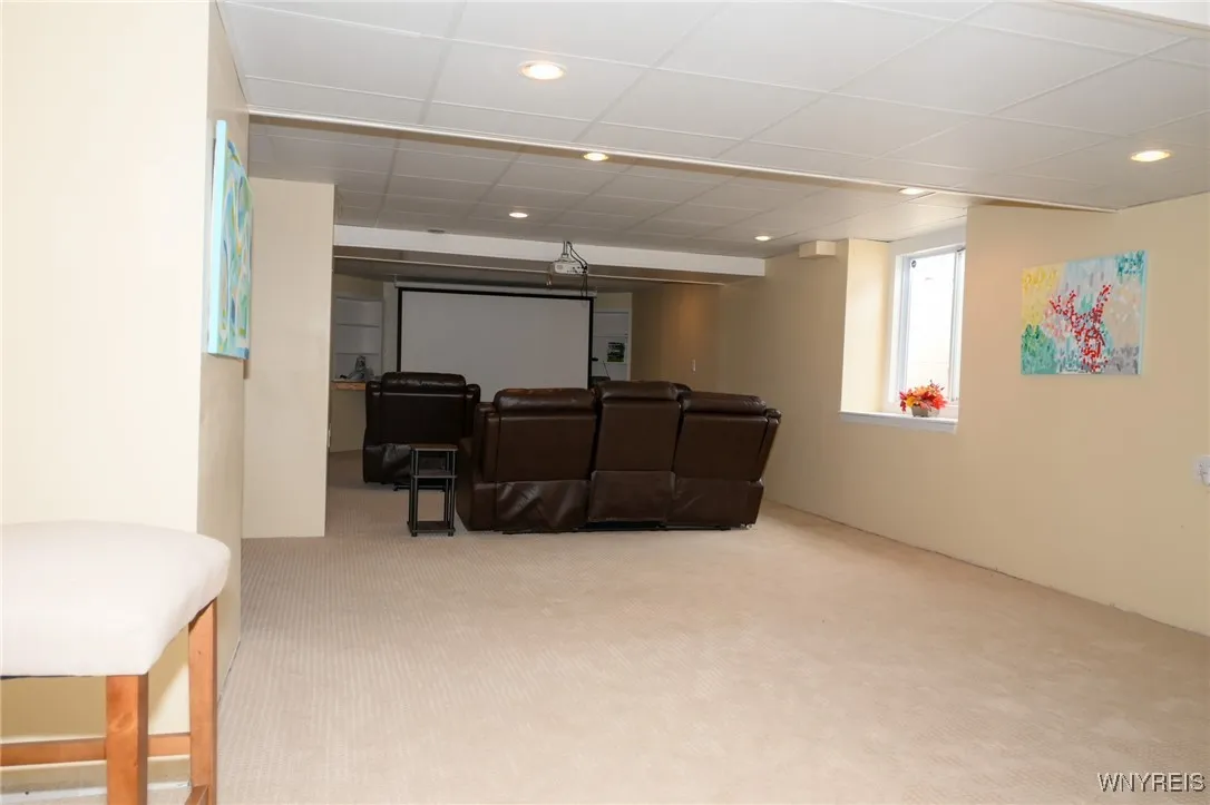 Entertainment room with projector and screen. Lots of room for other activities. Window to the center right is a full access window to the outside.