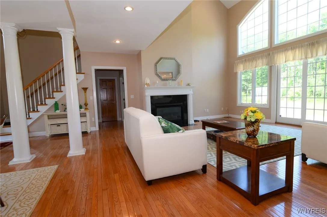Living room. Far entrance way is to half bath and first floor bedroom suite with walk in closet, bathroom with tub and shower, private toilet.
