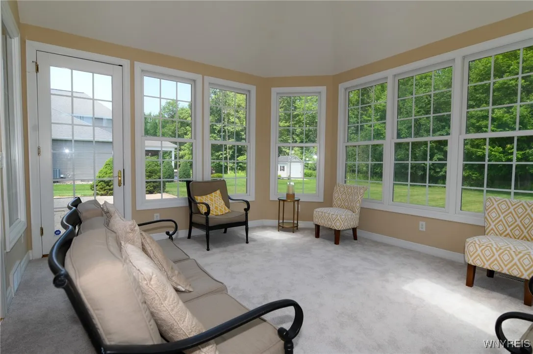 Sunroom with door to back stone patio