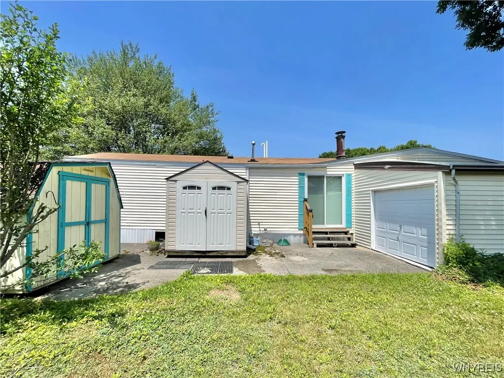 2 sheds plus garage w front and back doors.