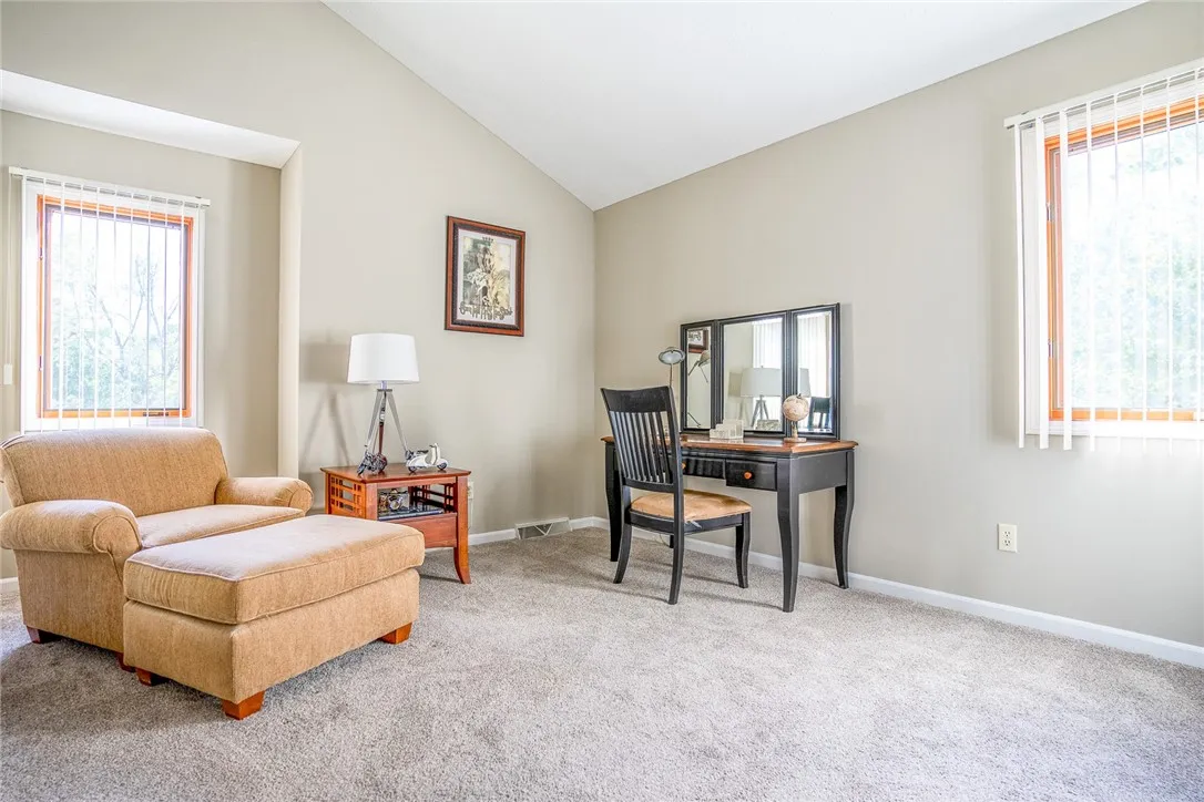 Typical bedroom with cathedral ceilings and wall-to-wall carpeting