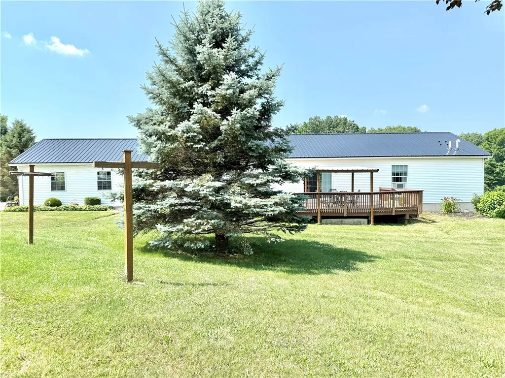 Back of house showing the deck. Septic located on the North side of the house.