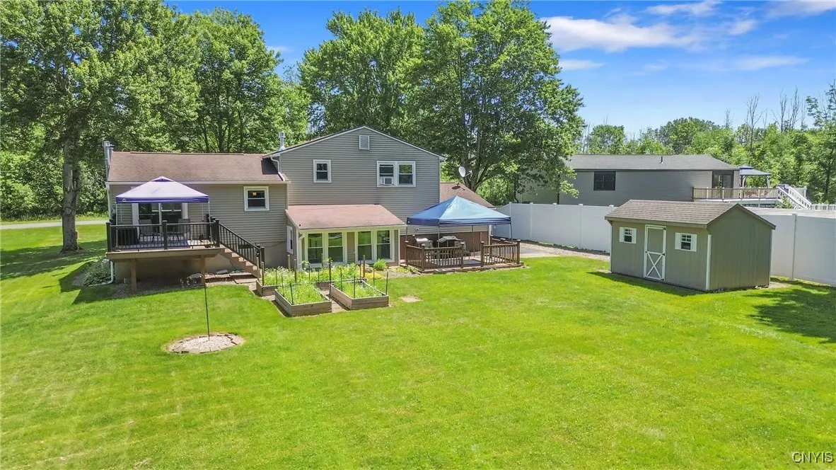 From this angle, take in the sizable storage shed—perfect for housing all your yard tools & outdoor gear—alongside the impressive new 8-foot vinyl privacy fence!