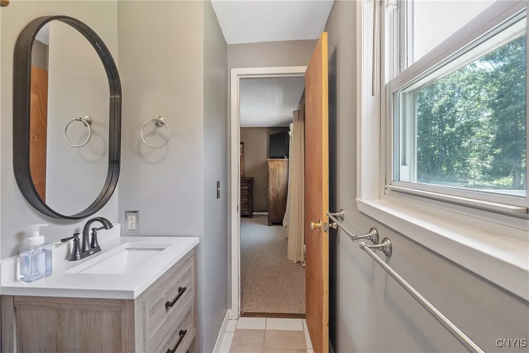 Just up the stairs on the upper level is the full bath, tastefully updated with new vanity & mirror.