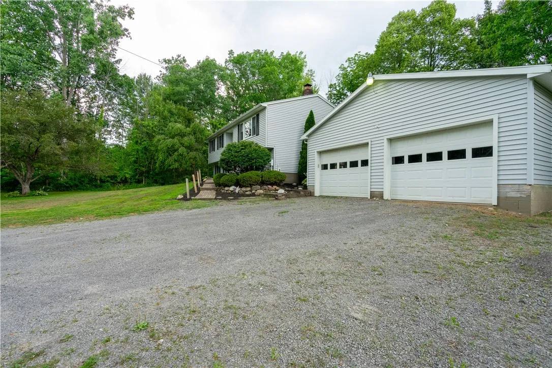 Large 2 car garage has gas line, is fully insulated and has 220 amp service