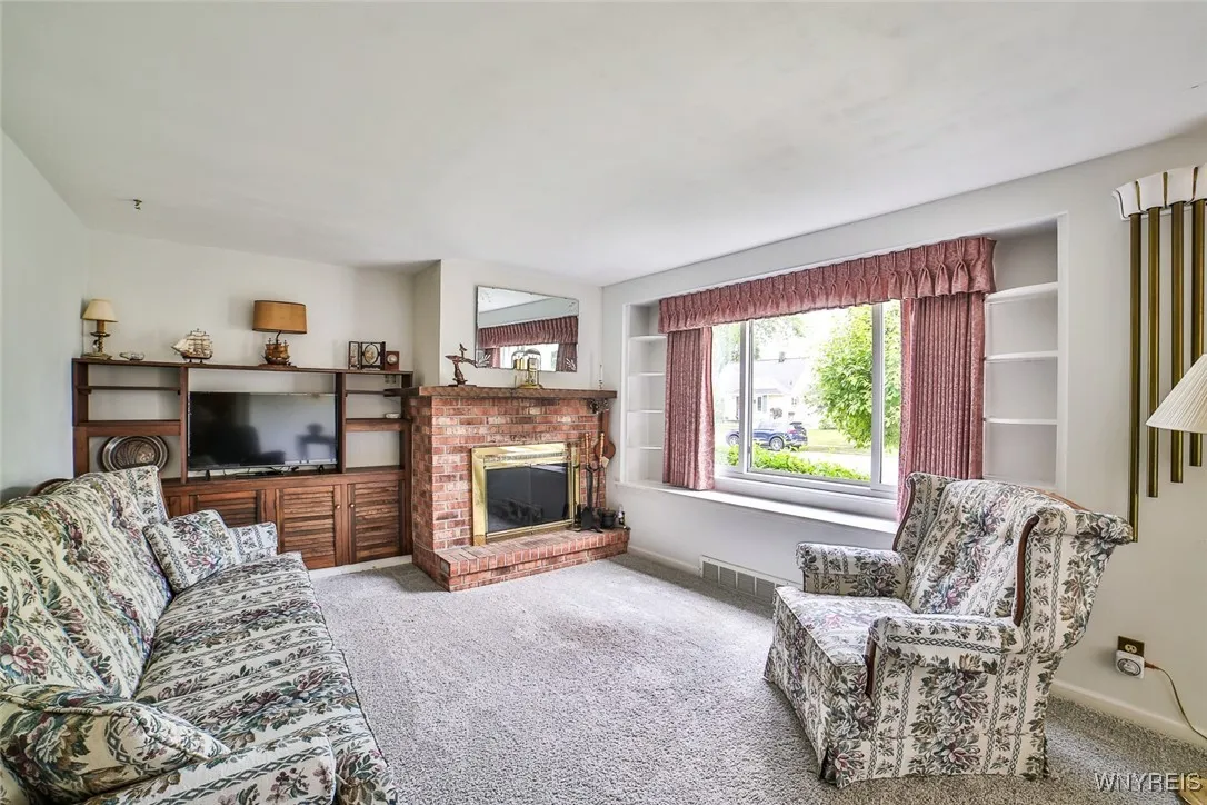 This room is so bright and cheerful! Note the pretty built in shelving that flanks the large window and the 