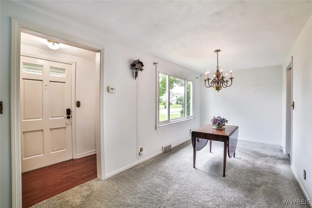 Formal dining space. There are hardwood floors under the pretty soft grey carpeting.