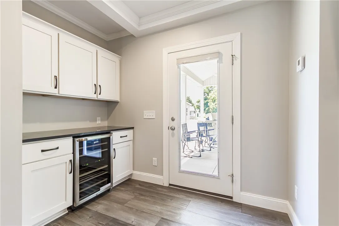 CUSTOM BUILT IN SERVING AREA WITH BEVERAGE COOLER.