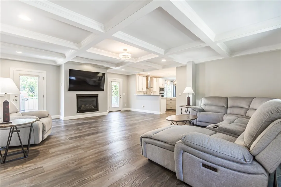 ENTERTAINMENT SIZED GREAT ROOM WITH BEAM CEILINGS WITH CROWN MOLDING, GAS FIREPLACE