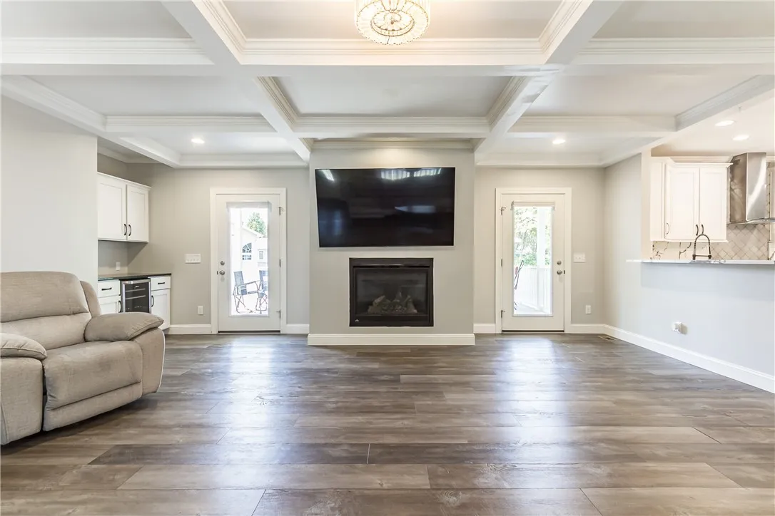 ENTERTAINMENT SIZED GREAT ROOM WITH BEAM CEILINGS WITH CROWN MOLDING, GAS FIREPLACE