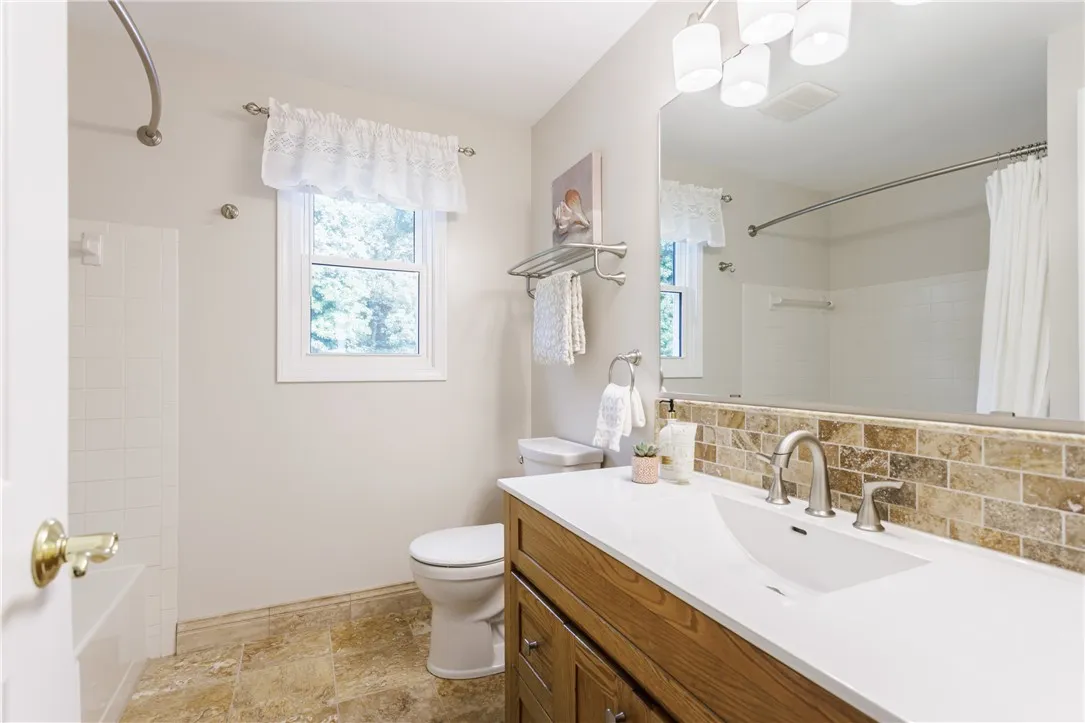 Hall bath renovated with new floor, vanity, toilet and fixtures.