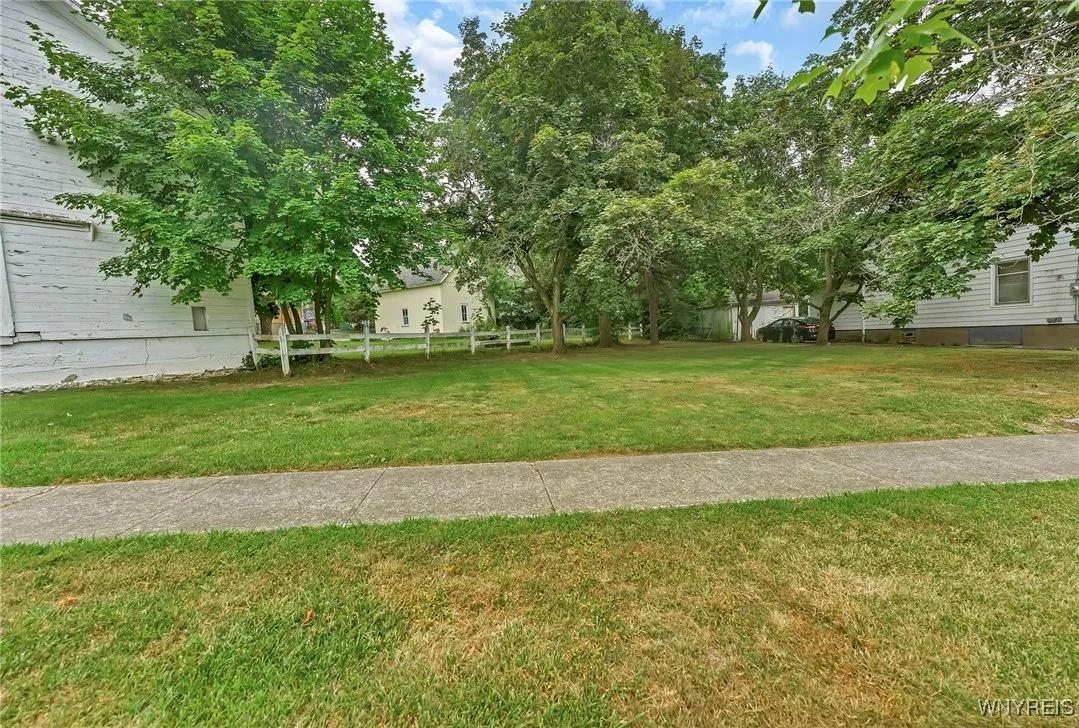 Expansive yard space includes extra land beyond the barn