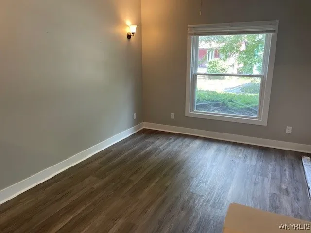 Updated living room with new drywall and flooring