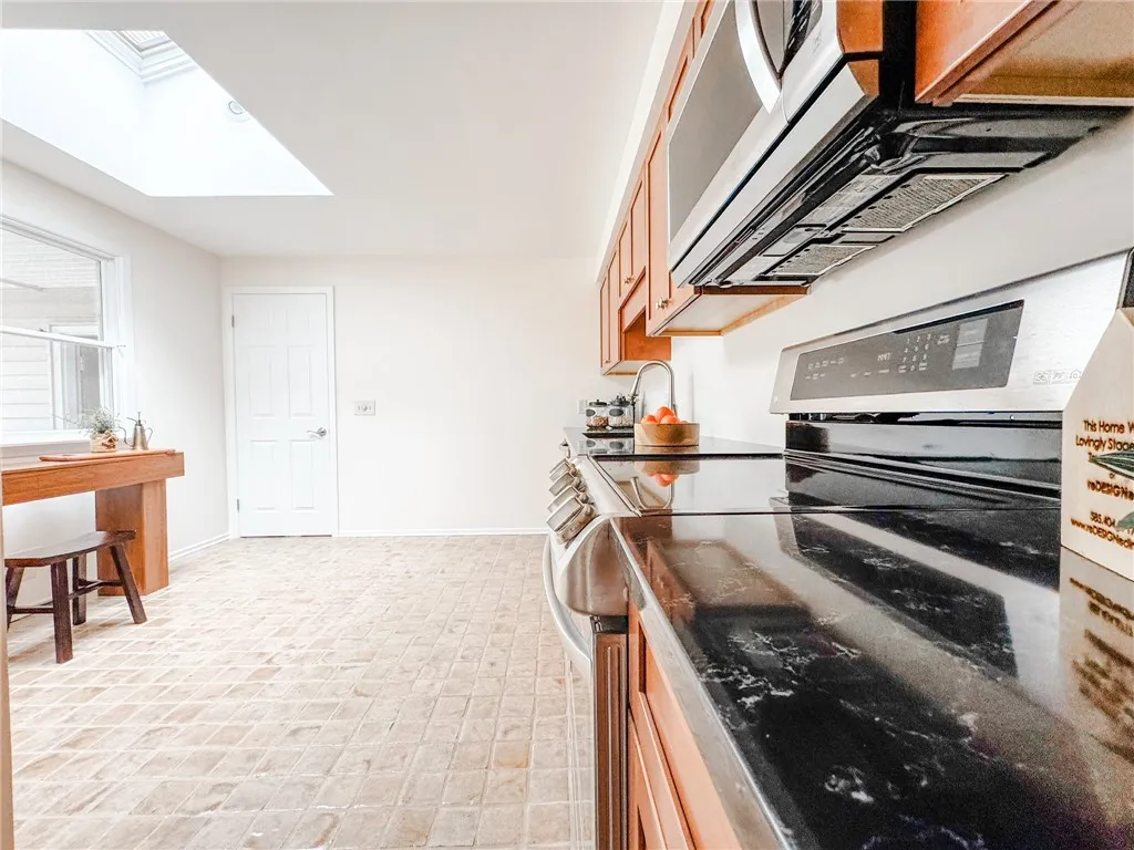 Quartz countertops and stainless steel appliances offer modern comnvenience to kitchen workspaces.