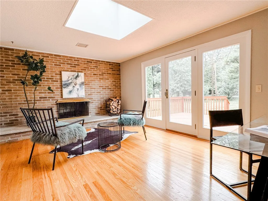 A skylight, fireplace and French doors to the deck seamlessly bridges indoor with outdoor entertainment areas.