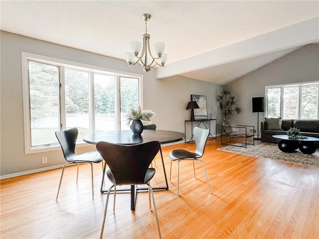 A wall of windows brightens the dining area.