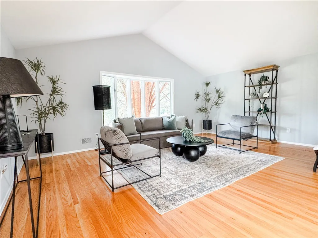 The bright. airy vaulted living room offers plenty of space for gatherings.