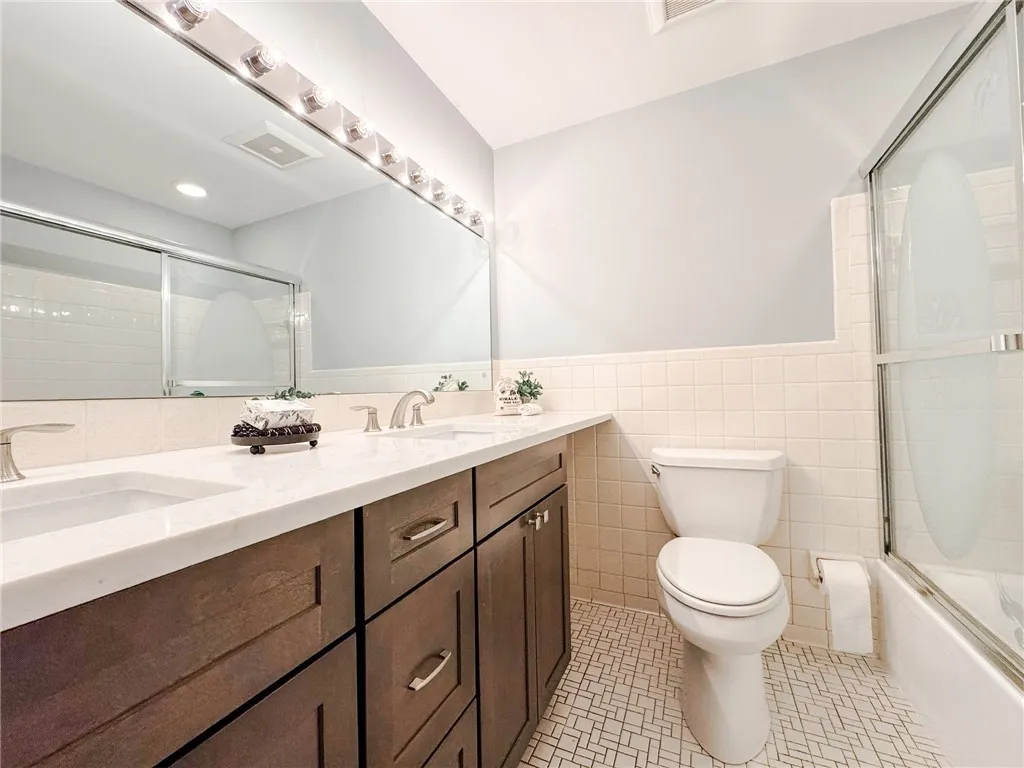The updated main bathroom features a double vanity.