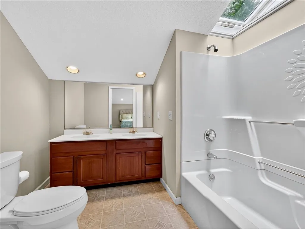 Primary full bathroom with double sink and updated shower surround