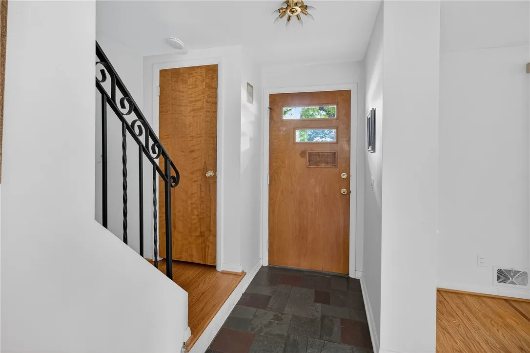 FRONT ENTRY FOYER W/ SLATE TILE AND COAT CLOSET