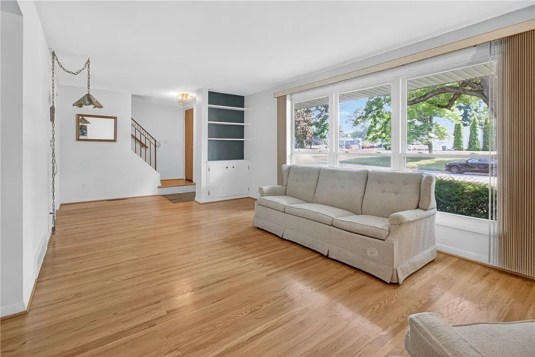 FORMAL LIVING ROOM W/ BUILT-IN SHELVING CABINET * TRIPLE REPLACEMENT WINDOWS * GORGEOUS HARDWOOD FLOORING * NATURAL LIGHT