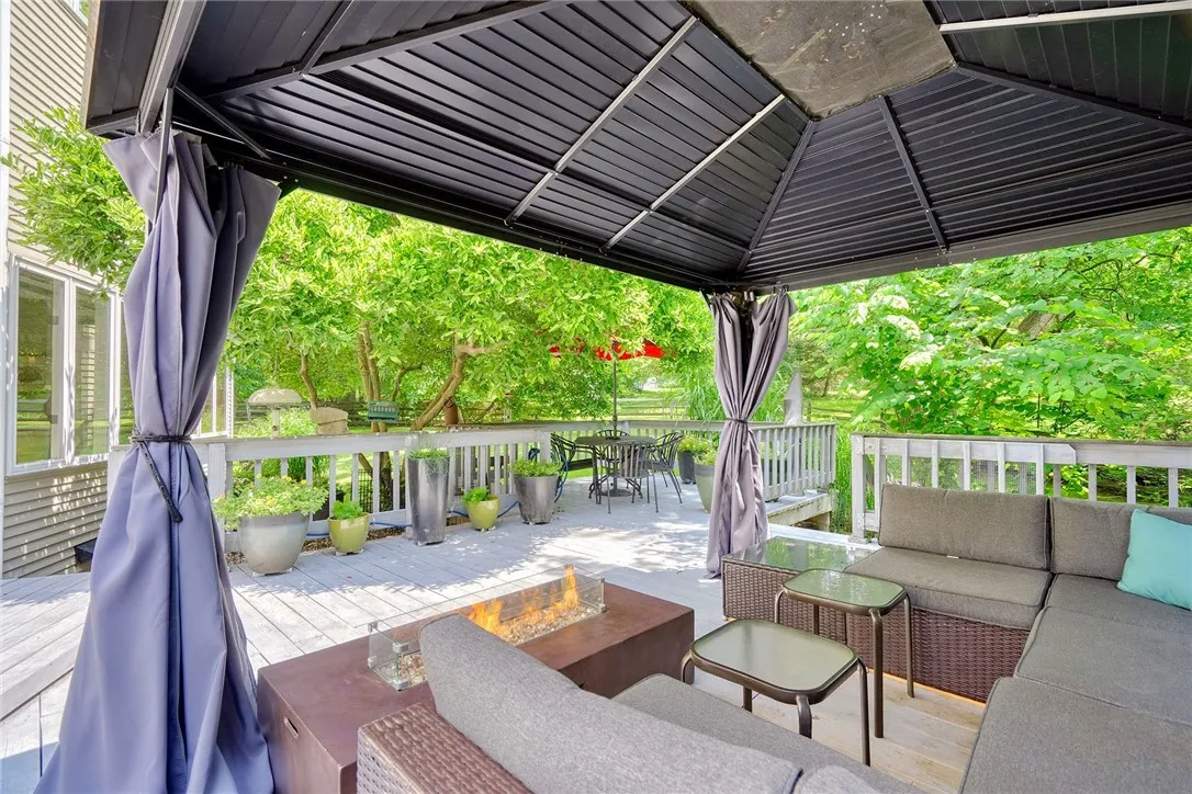 Spacious deck is an outdoor sanctuary surrounded by mature trees & Landscaping. FULLY FENCED BACKYARD with separate gravel and grass pet zones.