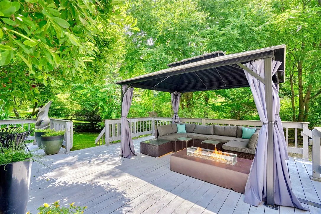Spacious deck is an outdoor sanctuary surrounded by mature trees & Landscaping. FULLY FENCED BACKYARD with separate gravel and grass pet zones.