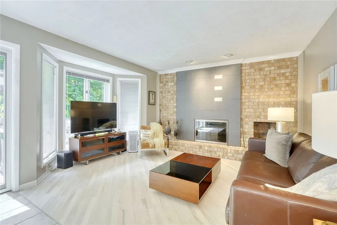 SUNLIT FAMILY ROOM with gas fireplace.