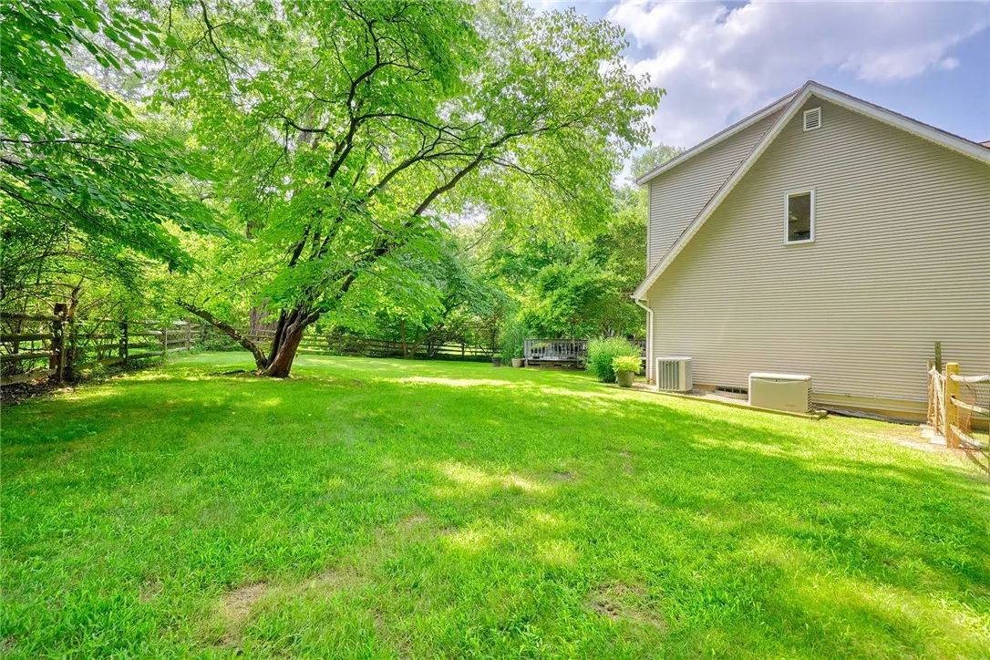 Spacious deck is an outdoor sanctuary surrounded by mature trees & Landscaping. FULLY FENCED BACKYARD with separate gravel and grass pet zones.