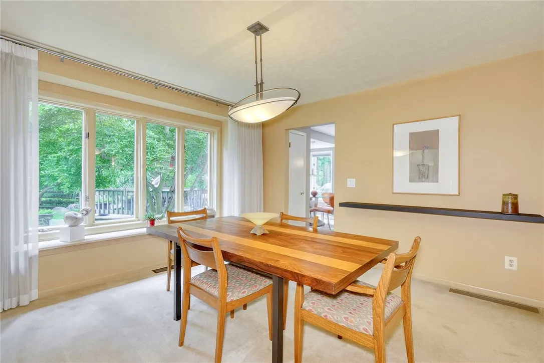 Living Room steps up to the Formal Dining Room with wall of windows overlooking the backyard!